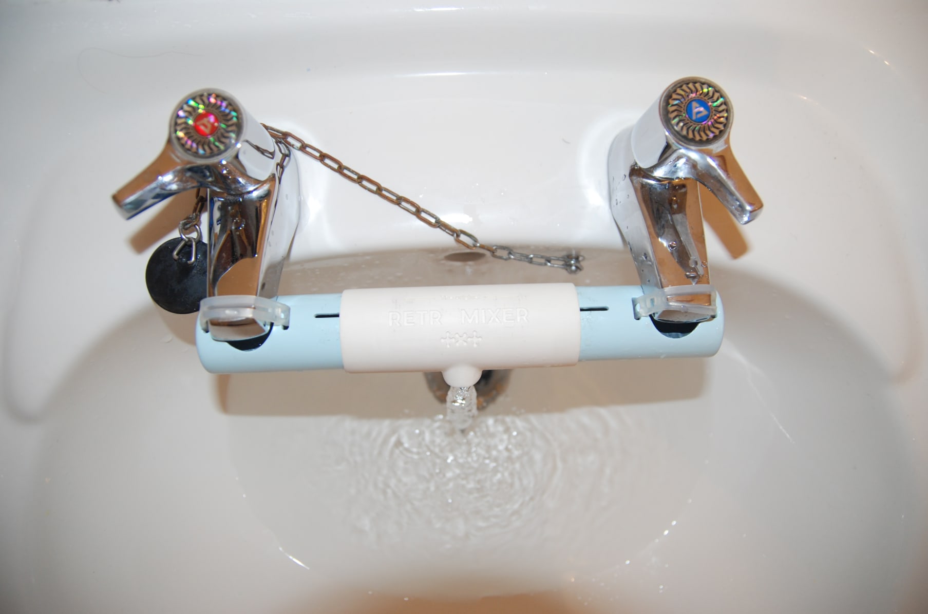 Home adaptor for sinks with separate taps for hot and cold water in